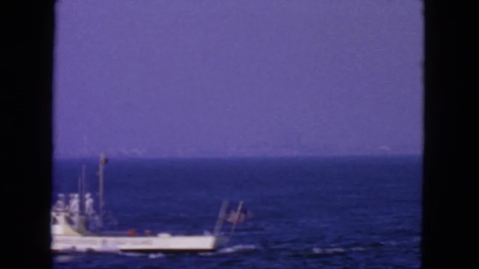 Handheld 8mm frame catches the Coast Guard boat partly at the edge of the ocean scene near San Francisco.