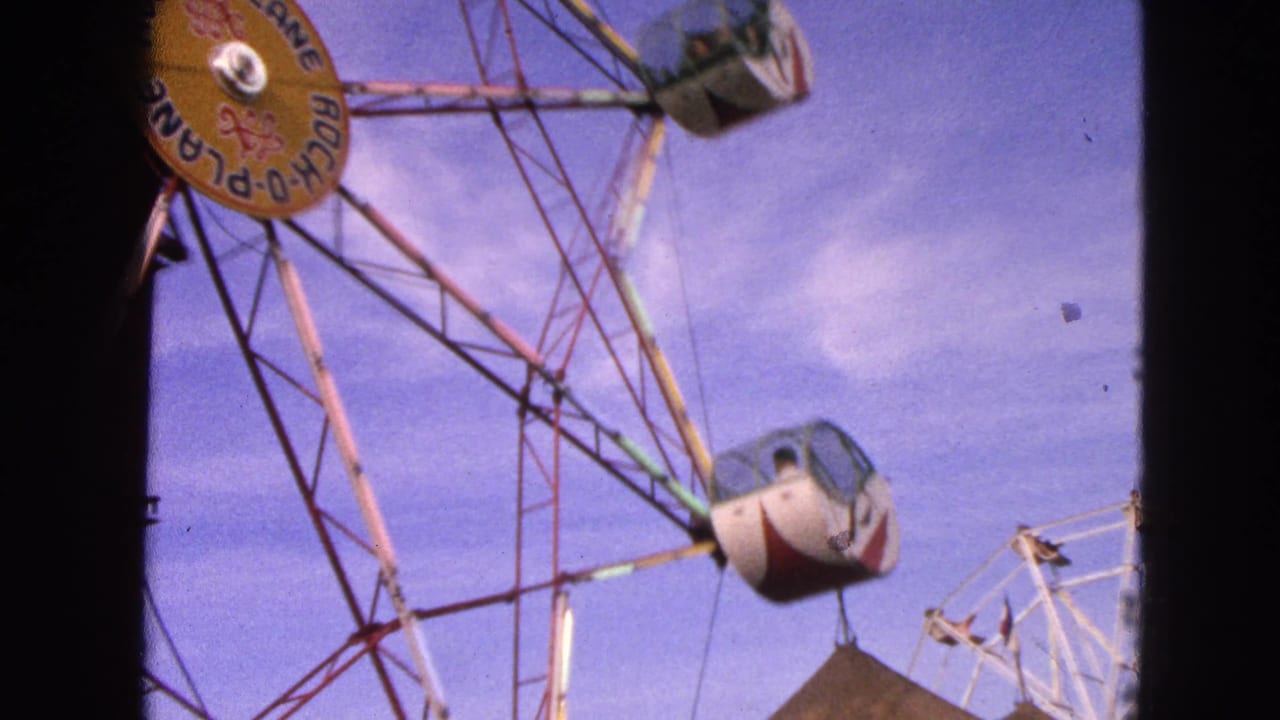 The Rock-O-Plane wheel continues rotating in Walworth, Wisconsin, with gondolas suspended from its colored metal structure.