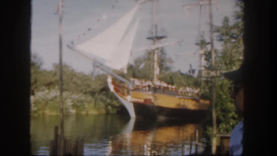 A Disneyland California 1962 visitor-shot view of a sailing ship attraction, with an EXIT sign and a partially visible man in the foreground.