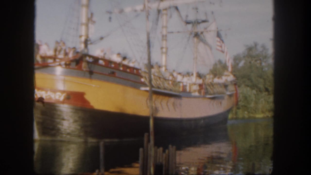 Close 1962 Disneyland view of a colorful replica sailing ship with guests standing along the deck and rigging overhead.