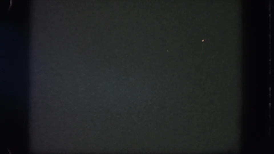 The final frame shows mostly dark sky with a single faint spark in 1962 Disneyland 8mm fireworks footage.