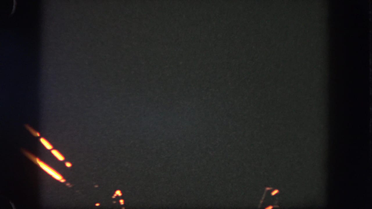 Orange fireworks streaks cross a dark sky with a few faint sparks.