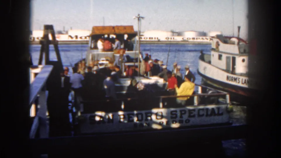 1962 San Diego harbor footage showing passengers on a dock beside the San Pedro Special, with another vessel and Mobil tanks beyond.