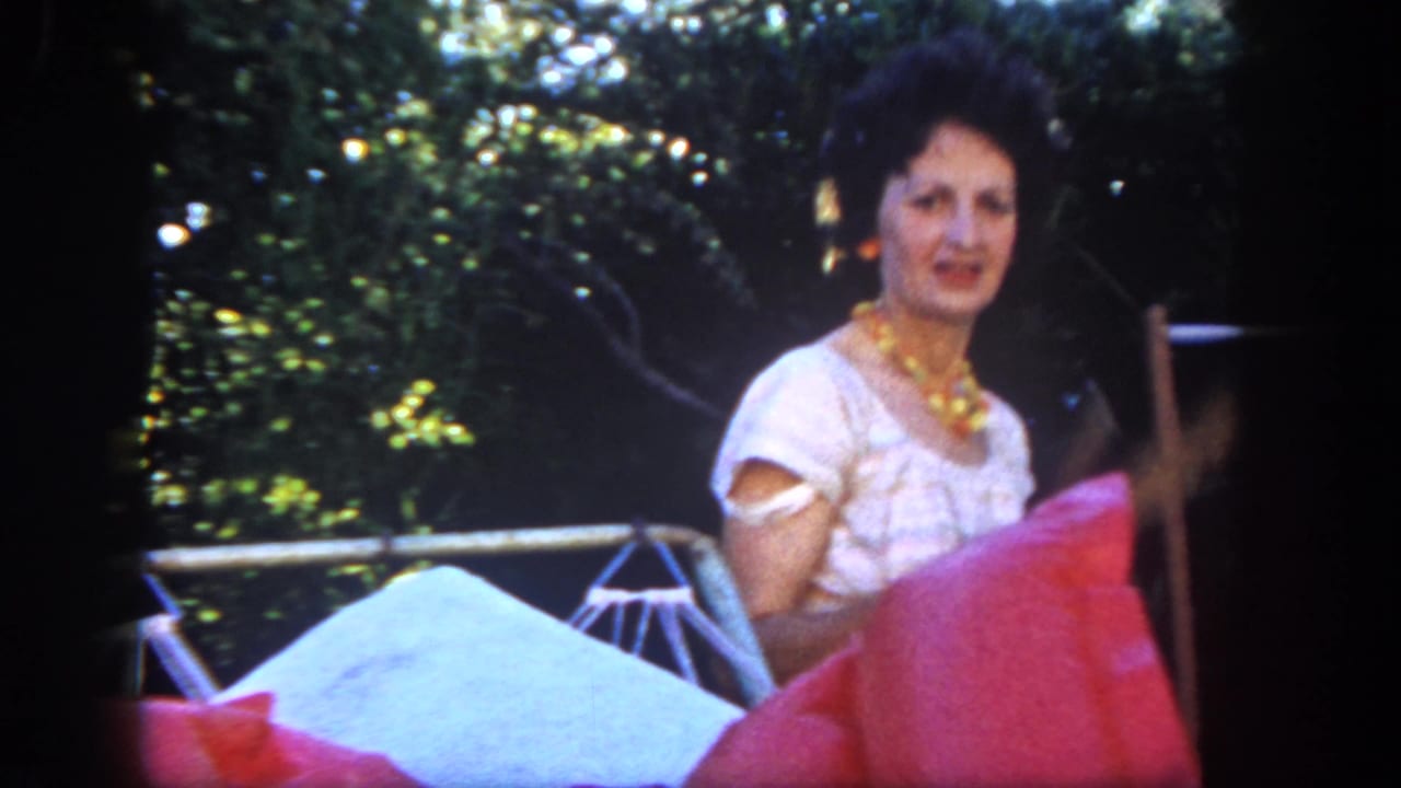 A woman in a white dress appears near bright patio cushions and outdoor furniture in the San Diego backyard scene.