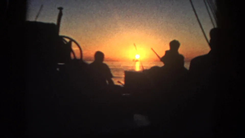 The final 1962 San Diego frame shows fishermen in silhouette on a boat with rods and rigging framing the orange sunset over open water.