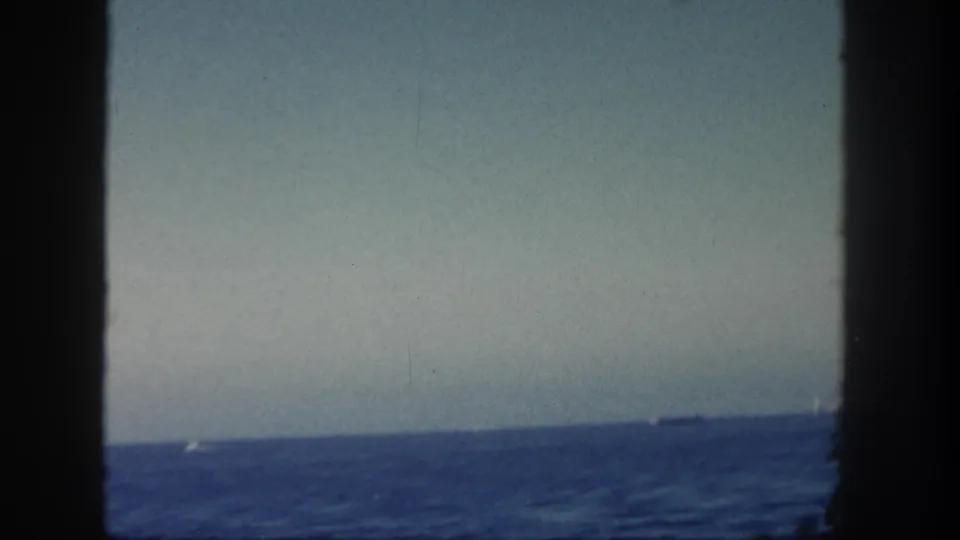 The final 1962 San Diego frame shows mostly open water and sky, with a faint distant vessel near the horizon and dark foreground borders.