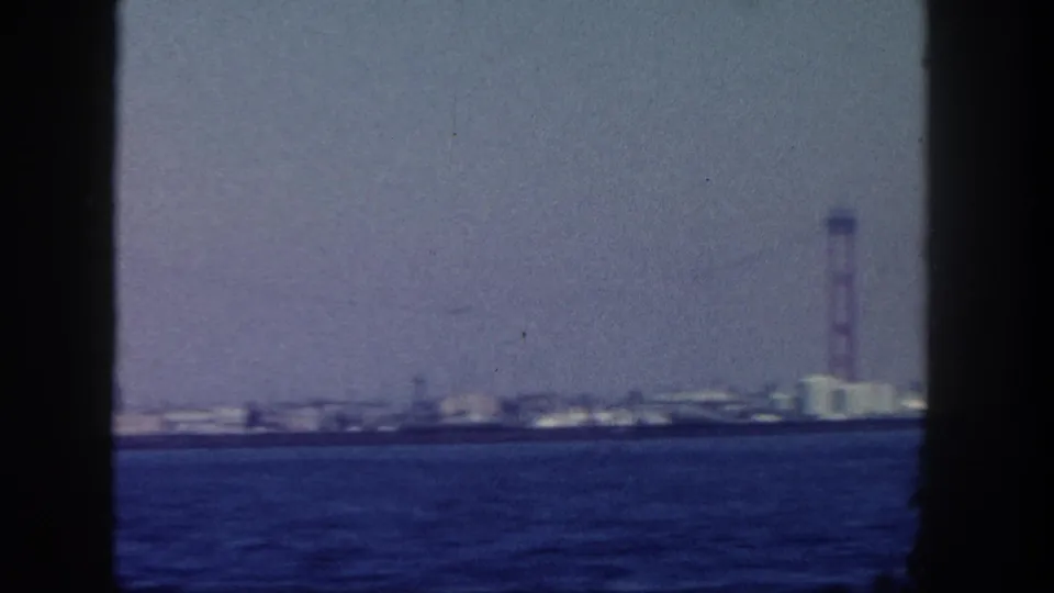 A San Diego waterfront industrial structure and tall tower appear across the water in the final 1962 home-movie frame.