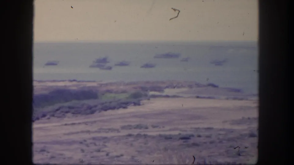 1962 San Pedro coastal view with several ships anchored offshore beyond a soft, hazy shoreline.