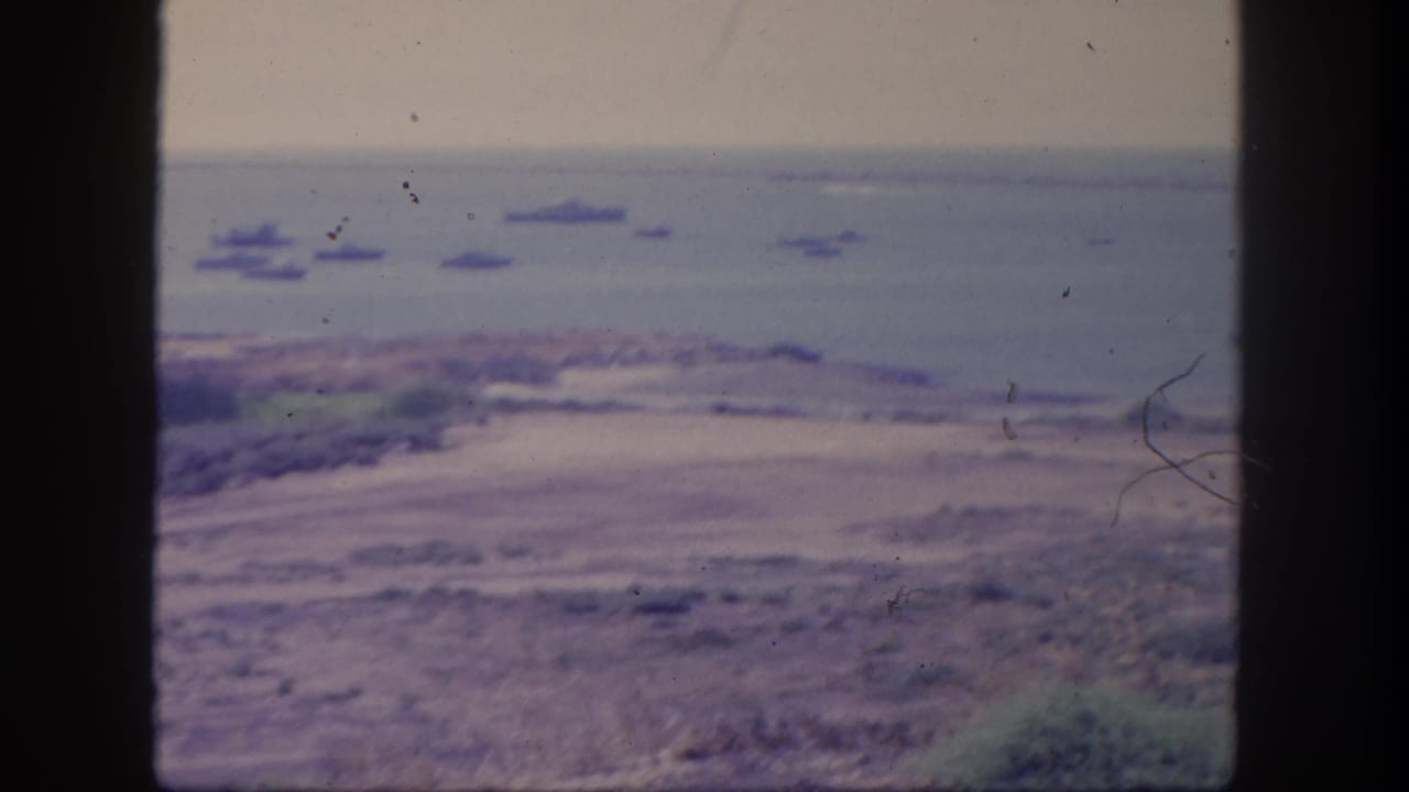 San Pedro harbor-area view showing distant ships on the water and a muted coastline from an elevated home-movie vantage.