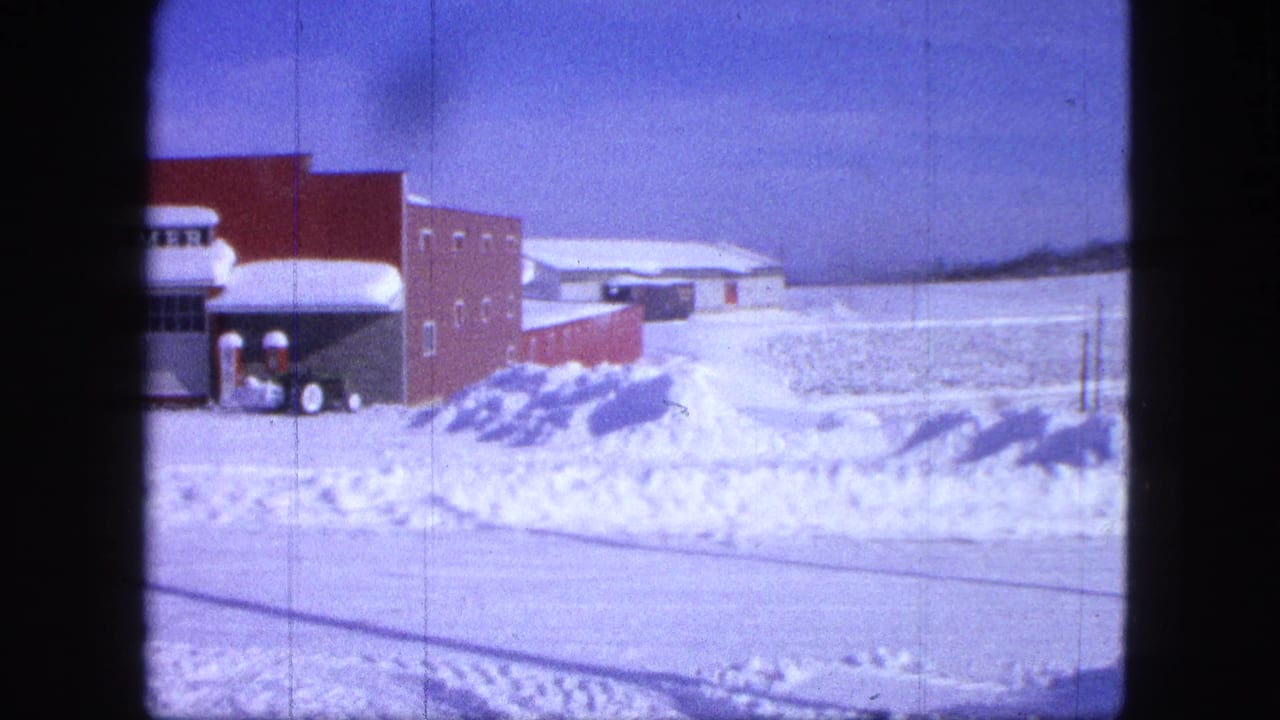 Red brick storefront with a HOMMER sign, snowbanks, and a plow vehicle near the entrance.