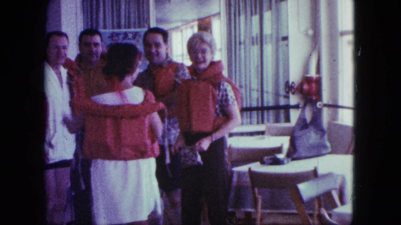 In a 1963 cruise-ship interior, several adults stand near tables and windows while adjusting orange-red life preservers.