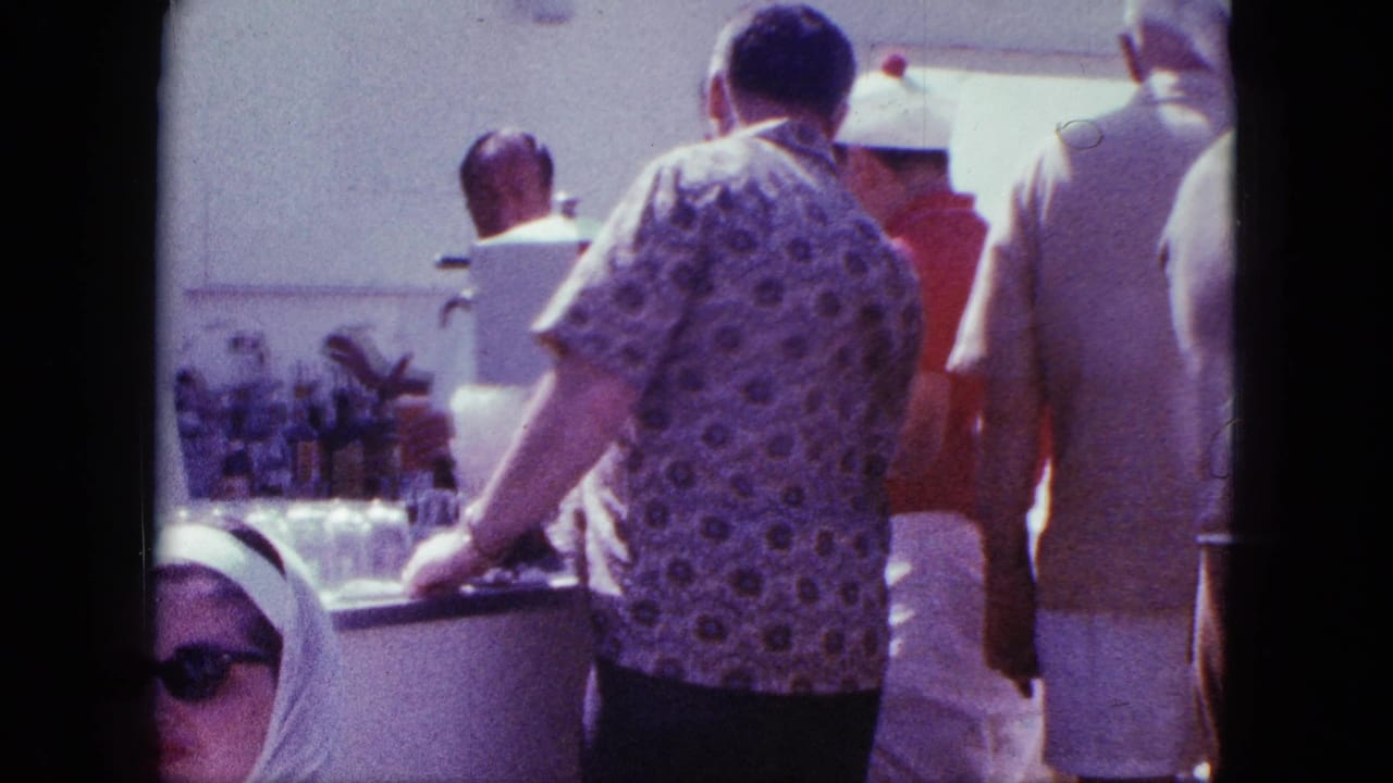 Adults gathered at a bright counter while a bartender works behind it.