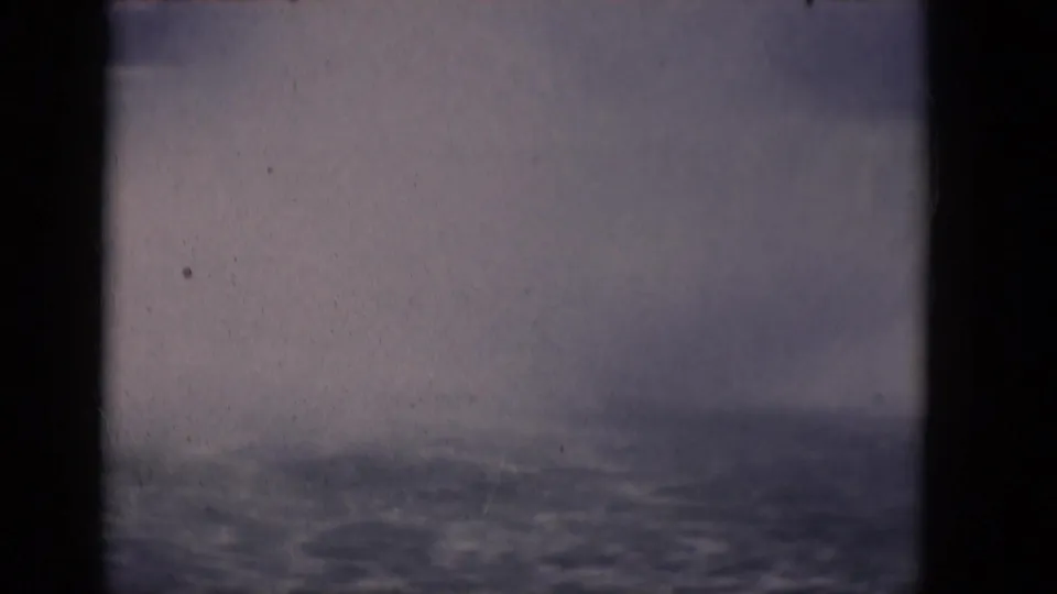 1964 8mm view of Horseshoe Falls on the Niagara River, with mist rising behind dark vertical frame edges.