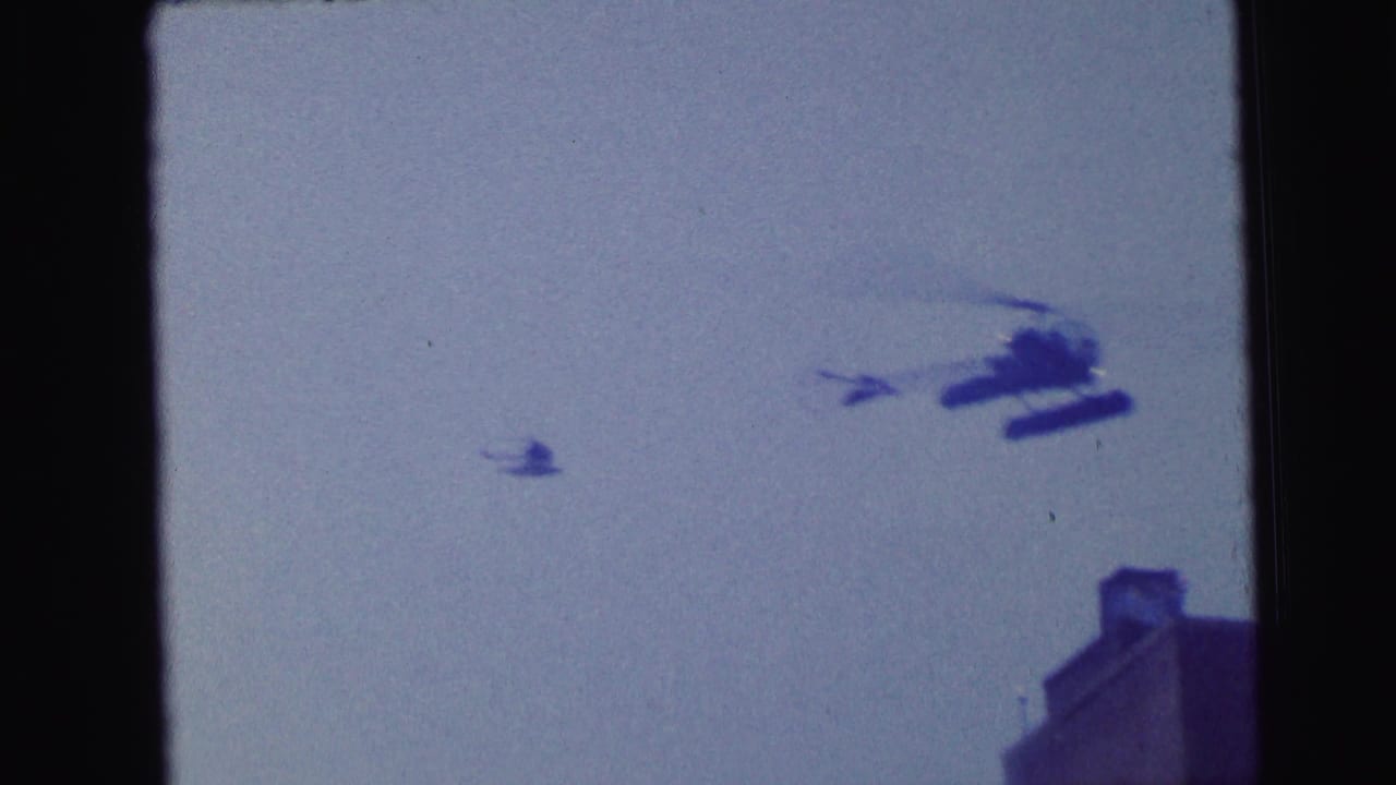 Helicopter and small distant aircraft shape over a rooftop corner.