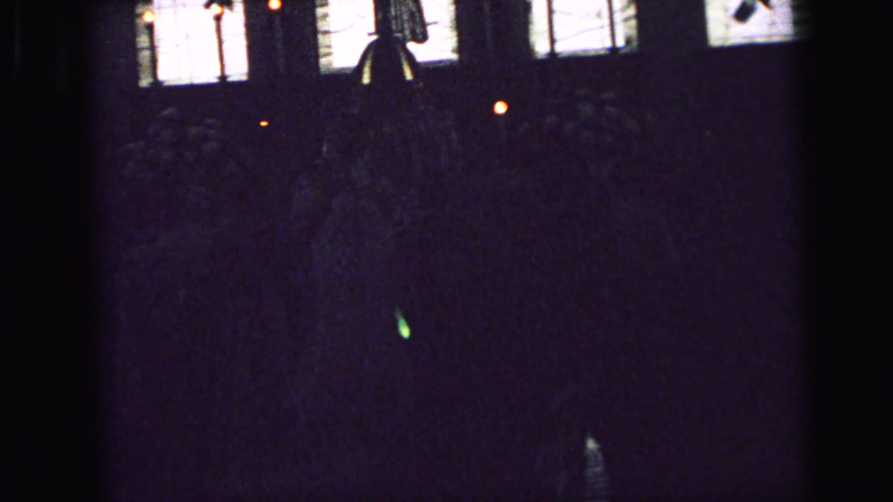 Dark church interior with bright windows above shadowed pews.