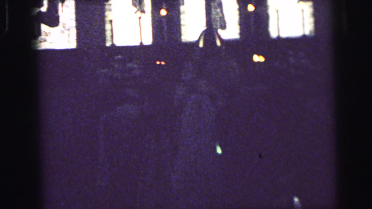Dim church view with bright windows and indistinct seated figures.