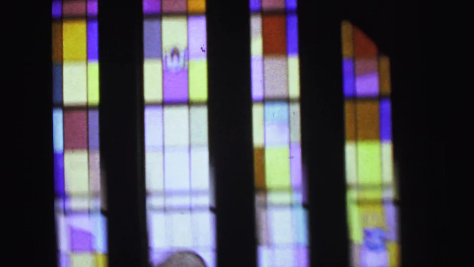 Colorful stained glass panels inside the Camden church, filmed in soft-focus 8mm during the 1964 ceremony.
