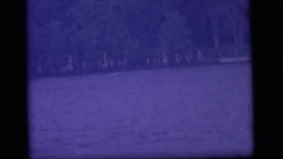 Soft 8mm Camden lake view from 1964, showing water and trees along the opposite shore.