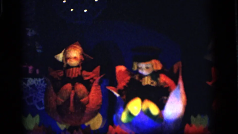 Glowing toy-like figures, bright yellow highlights, and colored shapes appear in a dark 1964 Camden home-movie frame.