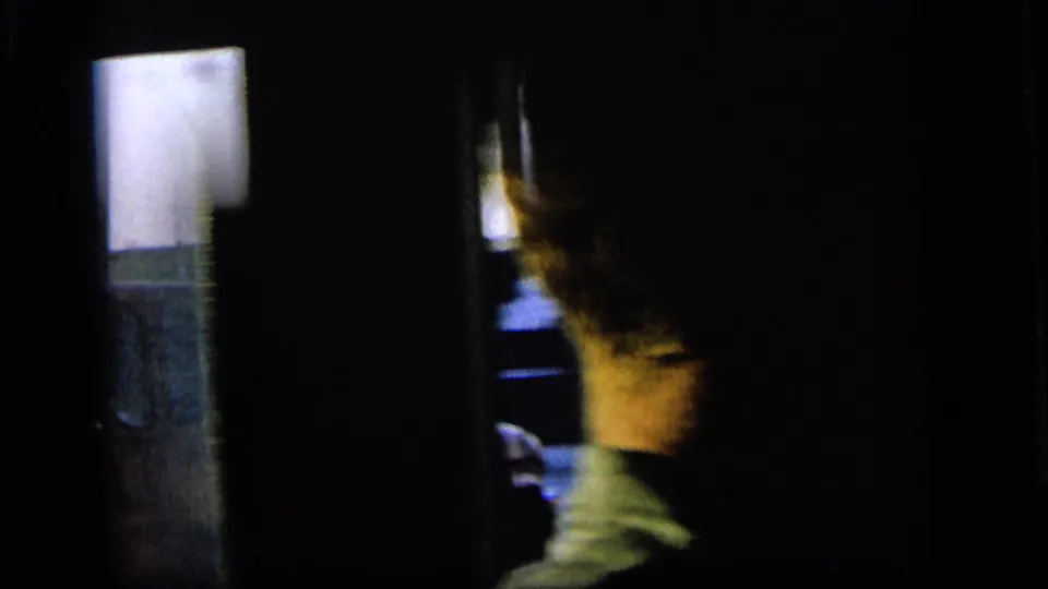 1964 Camden car interior frame with a partially visible passenger and blurred exterior scenery outside.