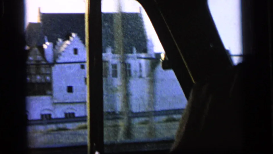 Camden street architecture passes outside the window, partly obscured by dark vehicle framing and a passenger's arm in the foreground.