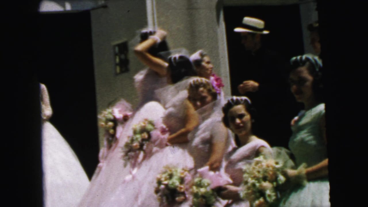 1964 Camden wedding party outside a church, with bridesmaids in light dresses, bouquets, veils, and guests clustered around the doorway.