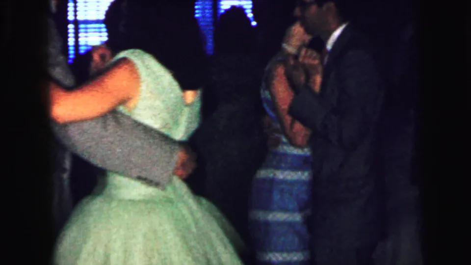 The 1964 Camden dance scene shows the green-dressed girl and gray-suited partner mid-turn, framed beside another couple in blue.