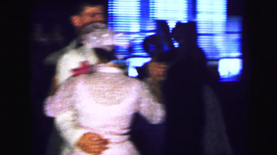 Bride and groom appear to dance at a 1964 Camden wedding reception, filmed in soft, grainy 8mm motion.