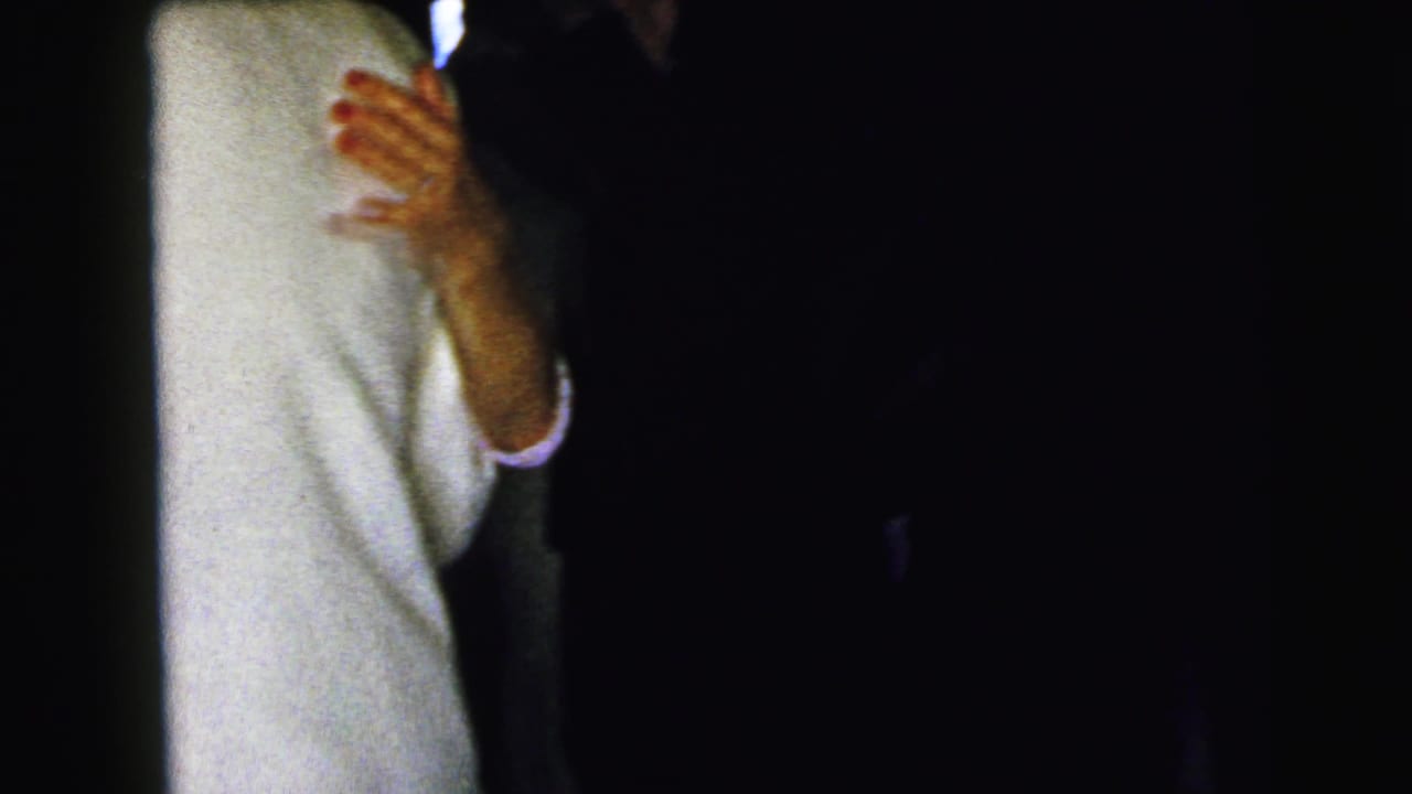 A dark, partially blocked 1964 Camden reception view shows dancers close together behind a vertical obstruction.