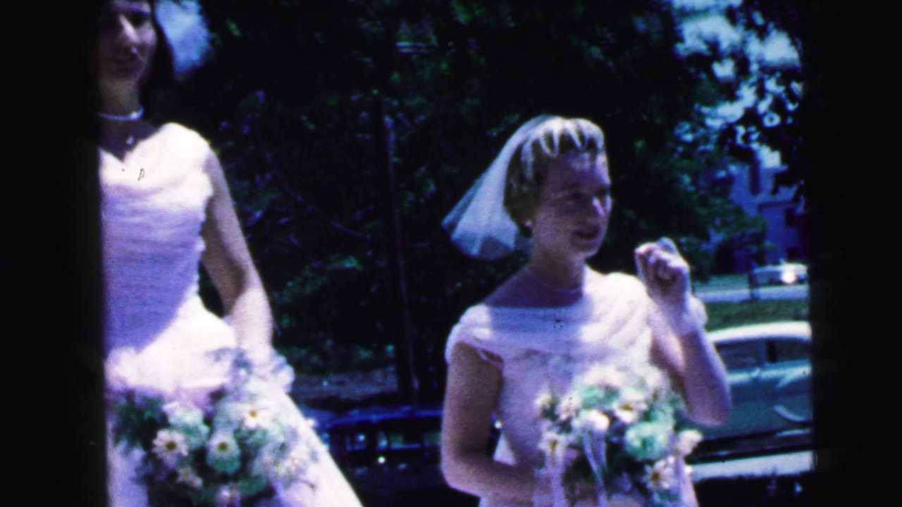 Two brides stand outdoors with bouquets, partly divided by a dark film-frame edge.