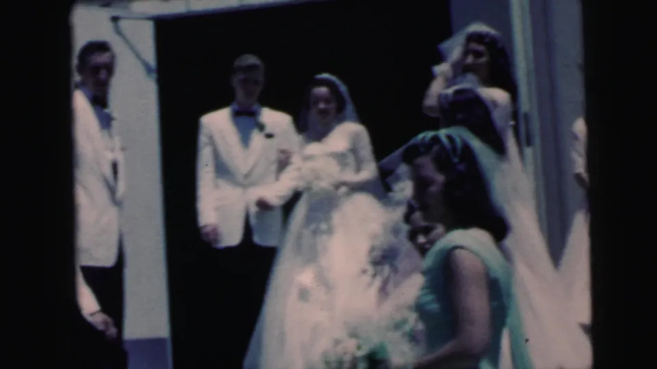 Bride, groom, attendants, and a mint-dressed woman appear outside the church in 1964 Camden wedding home-movie footage.