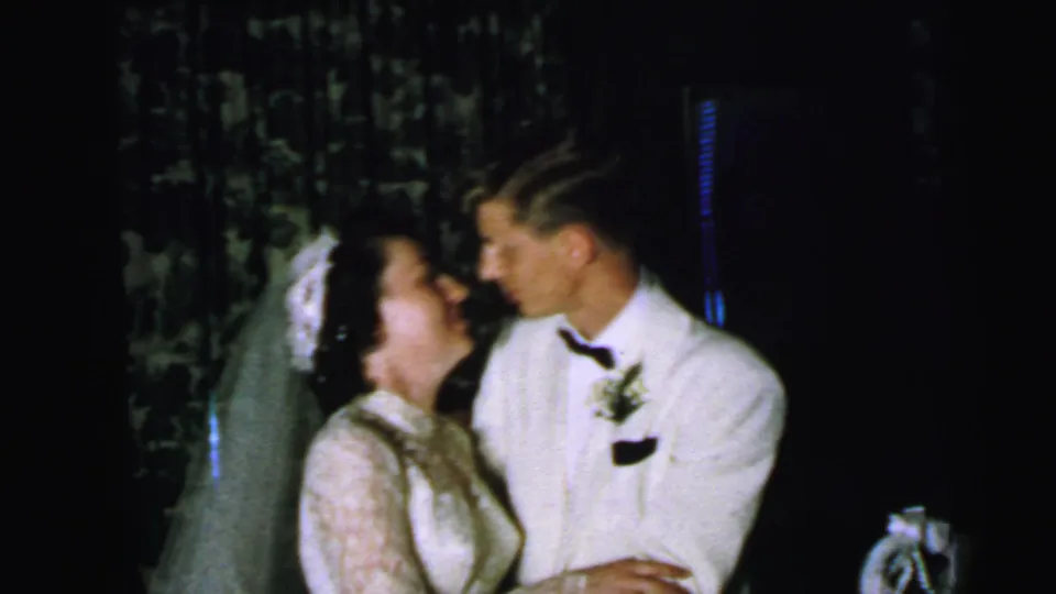 The bride and groom look at one another after kissing in this 1964 Camden, New Jersey 8mm wedding home movie.