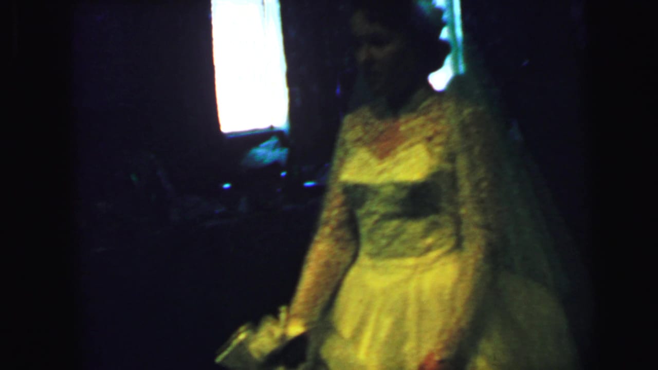 The bride remains in a dim room, her white gown and bouquet catching yellowish 8mm light near a bright window.
