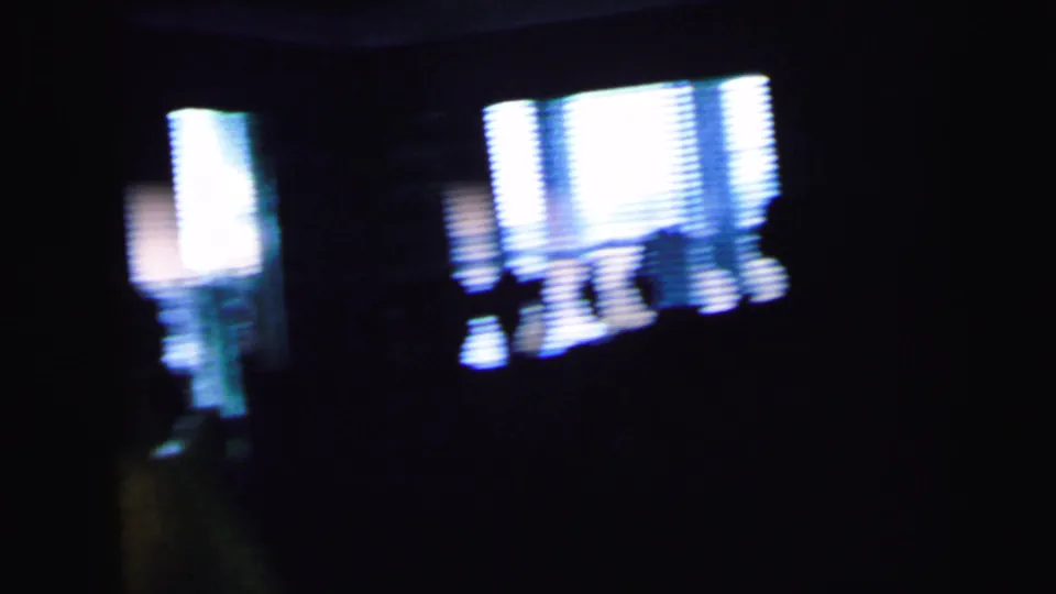 The final frame shifts to silhouetted people and bright windows inside the same dim wedding interior.