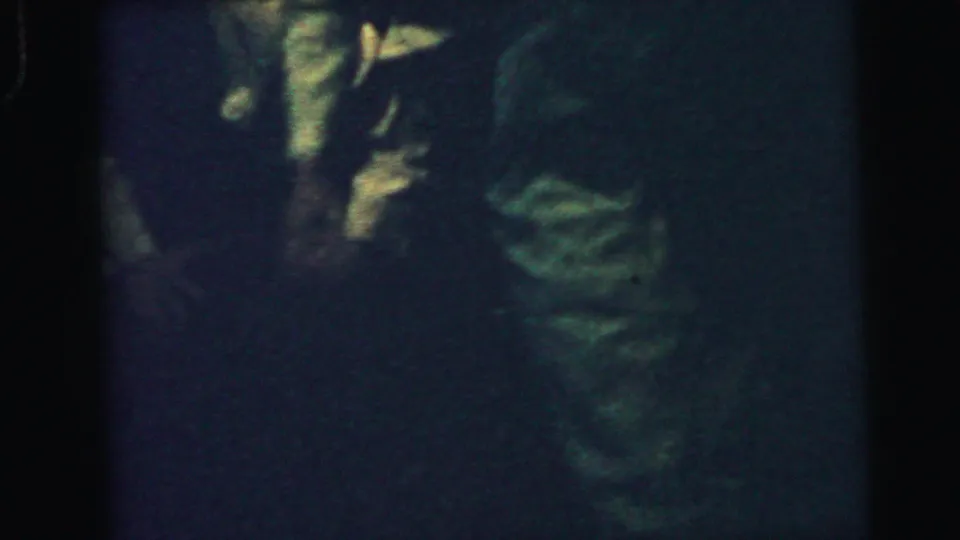 The final frame shows a dark, grainy interior with partial figures and light clothing visible through heavy underexposure.