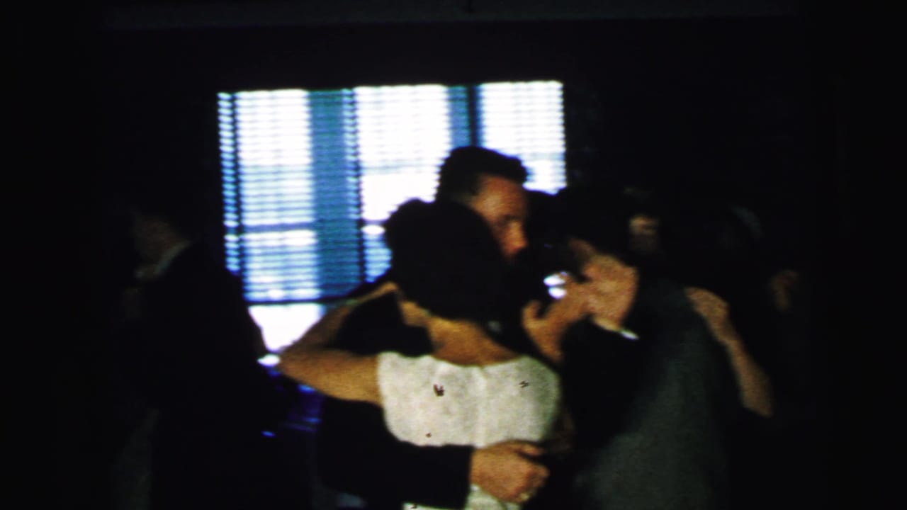 Bride and groom appear to dance at a 1964 Camden wedding reception, surrounded by other couples in a dim indoor space.