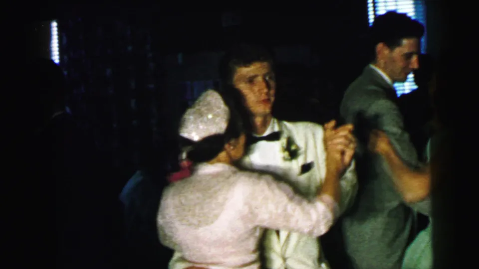 In the Camden wedding reception footage, the veiled bride dances with a suited man as another couple moves beside them.