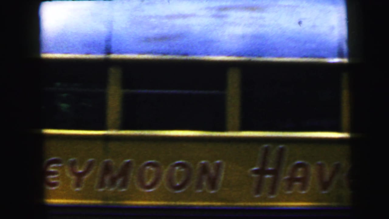 Partial sign reading '...EYMOON HAV...' in gold relief lettering against a dark background with a blue panel above.