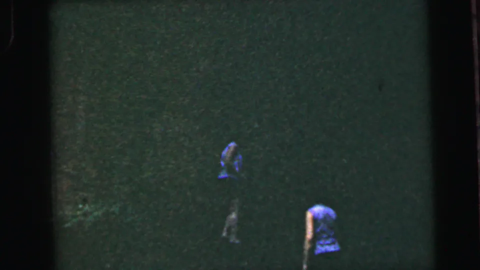 Two women at distance on a grassy slope near the clip's end; 8mm home movie, United States, circa 1964.