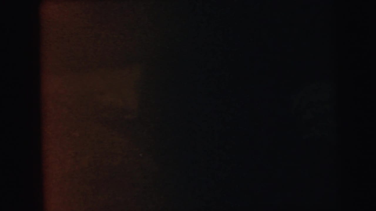 Dark, near-featureless 8mm film frame consistent with film-loading failure or end-of-reel light exclusion.