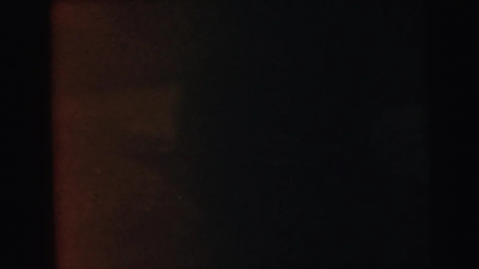 Dark, near-featureless 8mm film frame consistent with film-loading failure or end-of-reel light exclusion.
