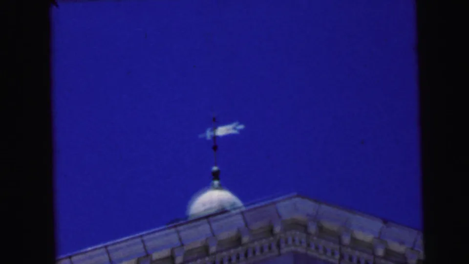 Close-up of a courthouse dome and arrow weather vane against a vivid blue sky, Camden, New Jersey, 1964, 8mm film