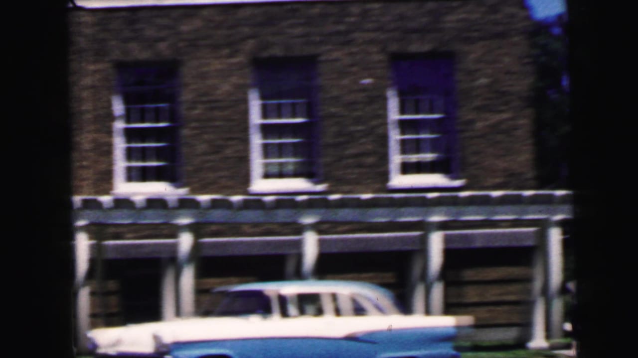 Blue and white American sedan, likely late-1950s or early-1960s, parked at a white columned building entrance; Camden NJ area, circa 1964