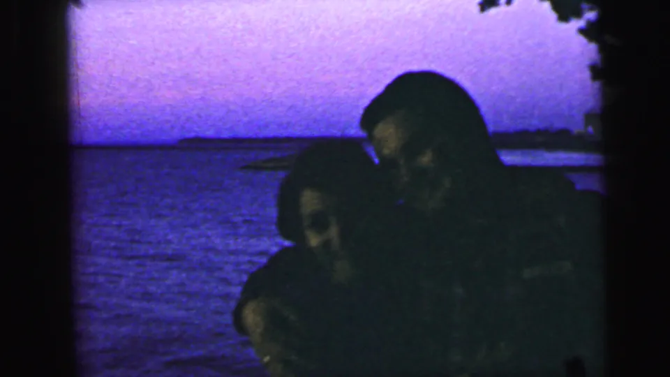In the Camden, New Jersey home-movie clip, the couple leans down together in a dark, affectionate pose by the water.