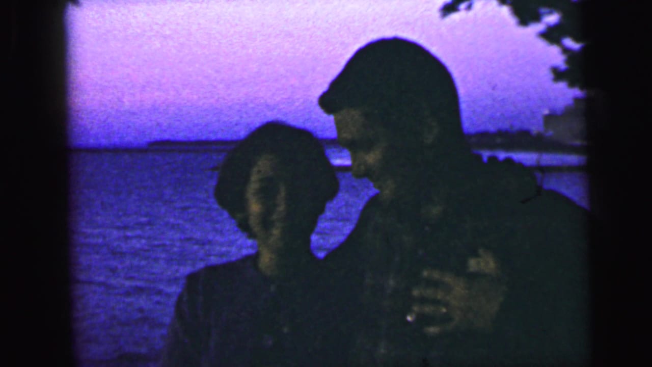 The couple appears in profile and partial silhouette near the water, consistent with the supplied 1964 Camden, New Jersey metadata.