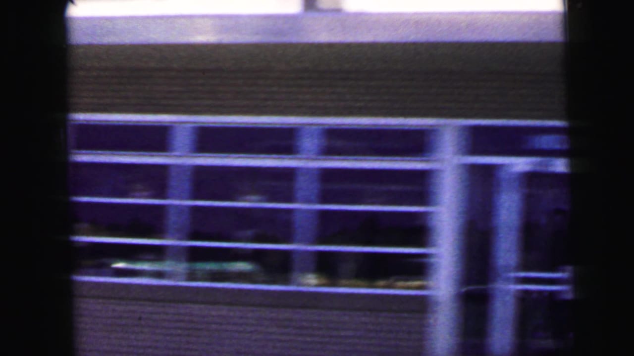 A brick or masonry building with broad windows appears briefly in the likely Camden, New Jersey travel view.