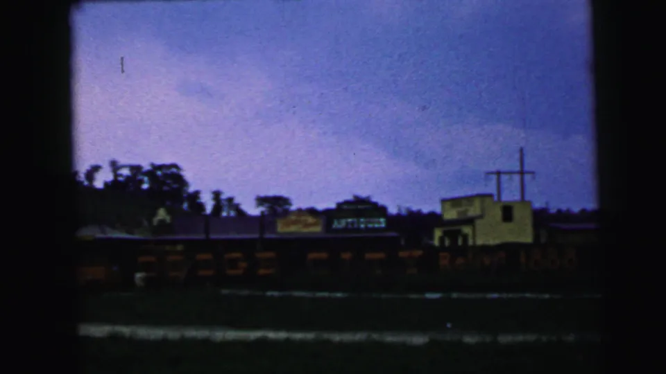 1964 Camden, New Jersey frame showing the rail car display stretched across the lower view, with the yellow cross-topped building to the right.