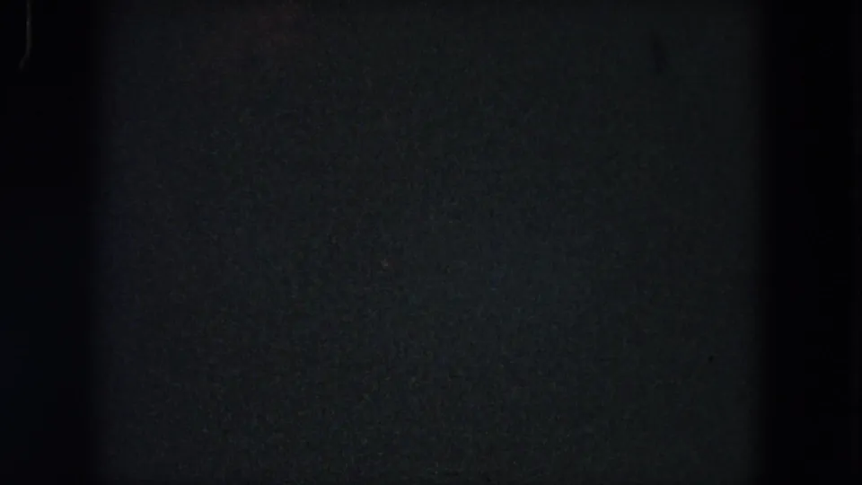 Final 1964 home-movie frame appears largely dark or underexposed, with only faint film grain and edge shading visible.