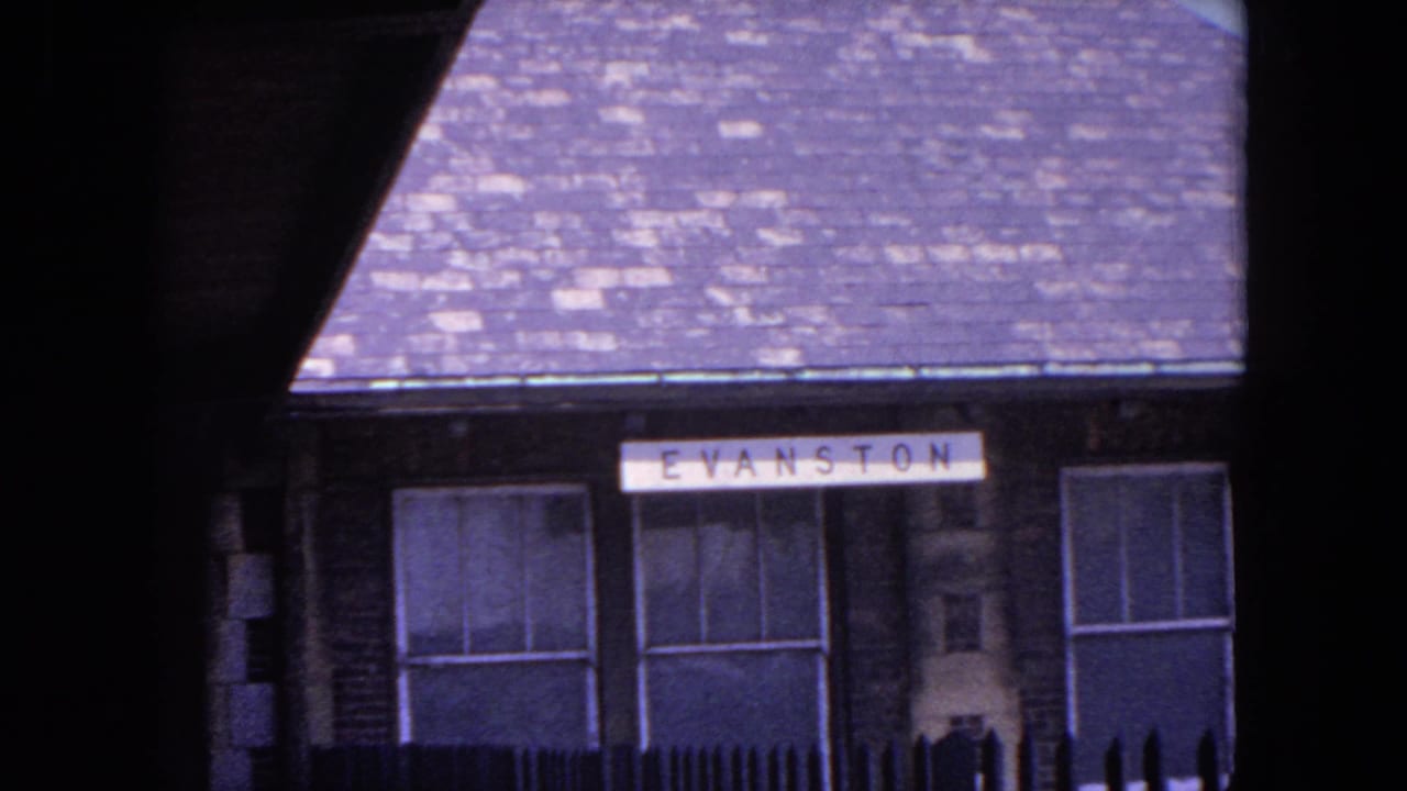 Evanston station building with a visible station sign and dark foreground framing.