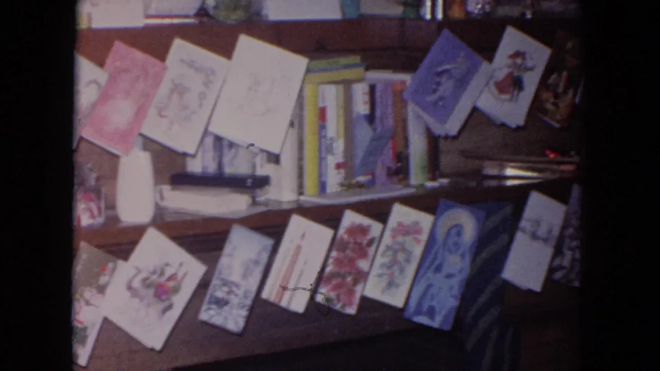 1964 Evanston home interior with holiday cards spread across a fireplace mantel, backed by books and a blue paper craft or decoration.